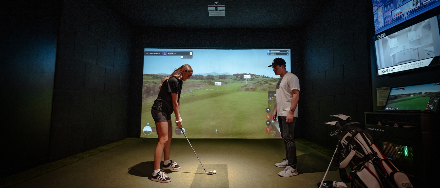 A Tee Box employee working on customizing a golf club for a member, contact us today - the premium golf shop.